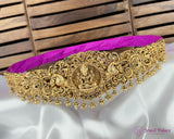 Gold necklace with intricate designs on a white and purple fabric background, branded 'Jewel Palace'.