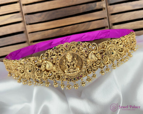 Gold necklace with intricate designs on a white and purple fabric background, branded 'Jewel Palace'.