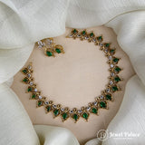 Gold and silver necklace with green gemstones on a mannequin bust, branded 'Jewel Palace'.