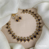 Gold necklace with purple stones on a white fabric background, brand 'Jewel Palace' visible.