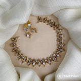 Gold necklace and earrings set on a white fabric background with 'Jewel Palace' branding.