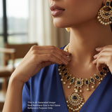 Close-up of a woman wearing an ornate necklace and earrings indoors.