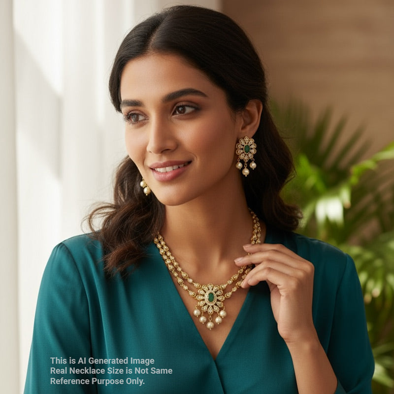 Woman wearing a gold necklace and earrings in a blurred indoor setting