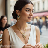 Woman wearing a gold necklace and earrings in an urban setting