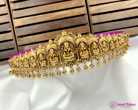 Decorative gold necklace with神像 on a white and wooden background, brand 'Jewel Palace' visible.