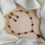 Jewelry set with necklace and earrings on a white fabric background, featuring 'Jewel Palace' brand.