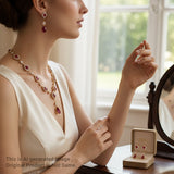 Woman wearing a necklace and earrings with a matching earring set in a box.