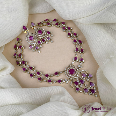 Ornate necklace with red stones on a white fabric background, featuring 'Jewel Palace' branding.