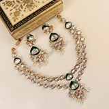 Gold-plated Indian jewelry set featuring a double-strand necklace, matching earrings, and a decorative box with floral inlay on a cream background.