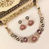 Gold-plated statement necklace and matching earrings with pink enamel medallions, black and white stone accents, and clear rhinestone borders, displayed on a cream floral box.