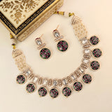 A traditional Indian jewelry set featuring a statement necklace, matching earrings, and a decorative gift box. The jewelry is made of gold-plated metal with white beads, clear crystals, and black, red, and green inlay work.