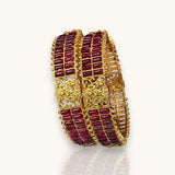 Gold and red bracelet on a white background