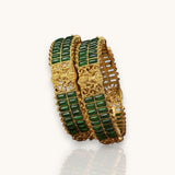 Gold and green bracelet set on a white background