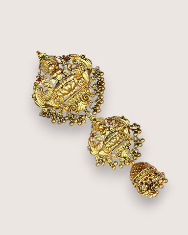 Gold earrings with intricate designs on a light gray background