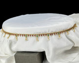 Decorative belt with beads on a white fabric background