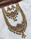 Ornate gold necklace with green beads on a white background