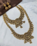 Gold necklace and earrings on a white surface