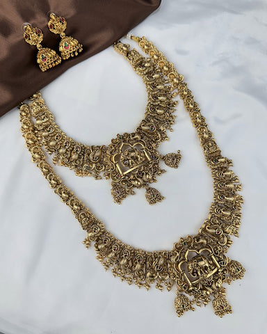 Gold necklace and earrings on a white surface
