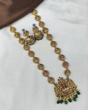 Gold necklace with green beads on a white background