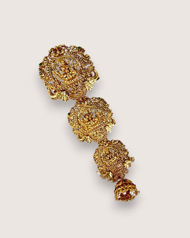 Gold floral earring on a light gray background