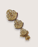 Gold earrings with intricate designs on a light gray background