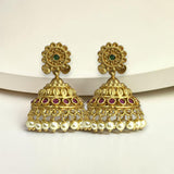 Gold earrings with pearls and gemstones on a white background