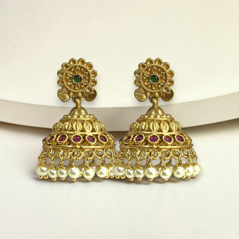 Gold earrings with pearls and gemstones on a white background