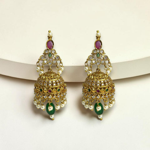 Pair of gold earrings with pearls and gemstones on a white background