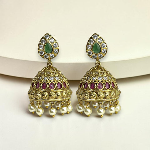 Gold earrings with green, purple, and pearl accents on a white background