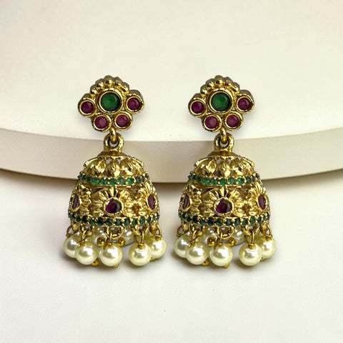 Gold earrings with pearls and gemstones on a white background