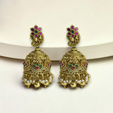 Ornate gold earrings with gemstones on a white background