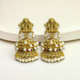 Gold earrings with pearls and red stones on a white background