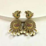 Gold earrings with pearls and gemstones on a white background