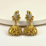 Gold earrings with intricate designs and gemstones on a white background