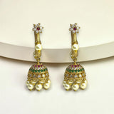 Gold earrings with pearls and gemstones on a white background
