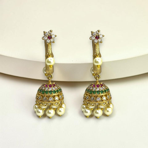 Gold earrings with pearls and gemstones on a white background