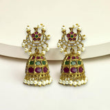 Ornate gold earrings with gemstones and pearls on a white background