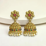 Gold floral earrings with red and green stones on a white background