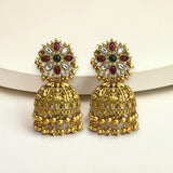 Gold earrings with gemstones on a light background