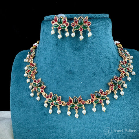 Jewelry set with necklace and earrings on a blue stand