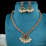 Jewelry set with necklace and earrings on a blue stand