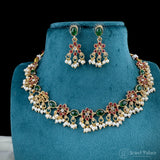Jewelry set with necklace and earrings on a blue stand, brand 'Jewel Palace' visible