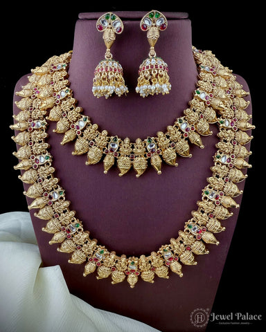 Gold necklace and earrings set on a purple stand with 'Jewel Palace' branding.