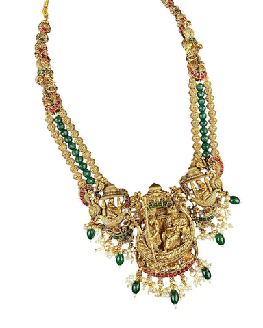 Gold necklace with green beads and intricate design on a white background