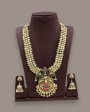 Gold-toned traditional Indian jewelry set featuring a multi-strand necklace with a large ornate pendant and matching drop earrings, displayed on a dark brown jewelry bust against a plain gray background.