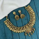 Gold necklace and earrings on a blue fabric background
