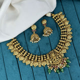 Gold necklace and earrings on a blue fabric background