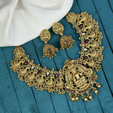 Gold necklace and earrings on a blue fabric background
