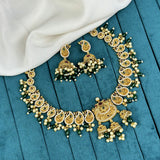 Gold necklace and earrings on a blue wooden surface