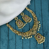 Gold necklace and earrings on a blue fabric background